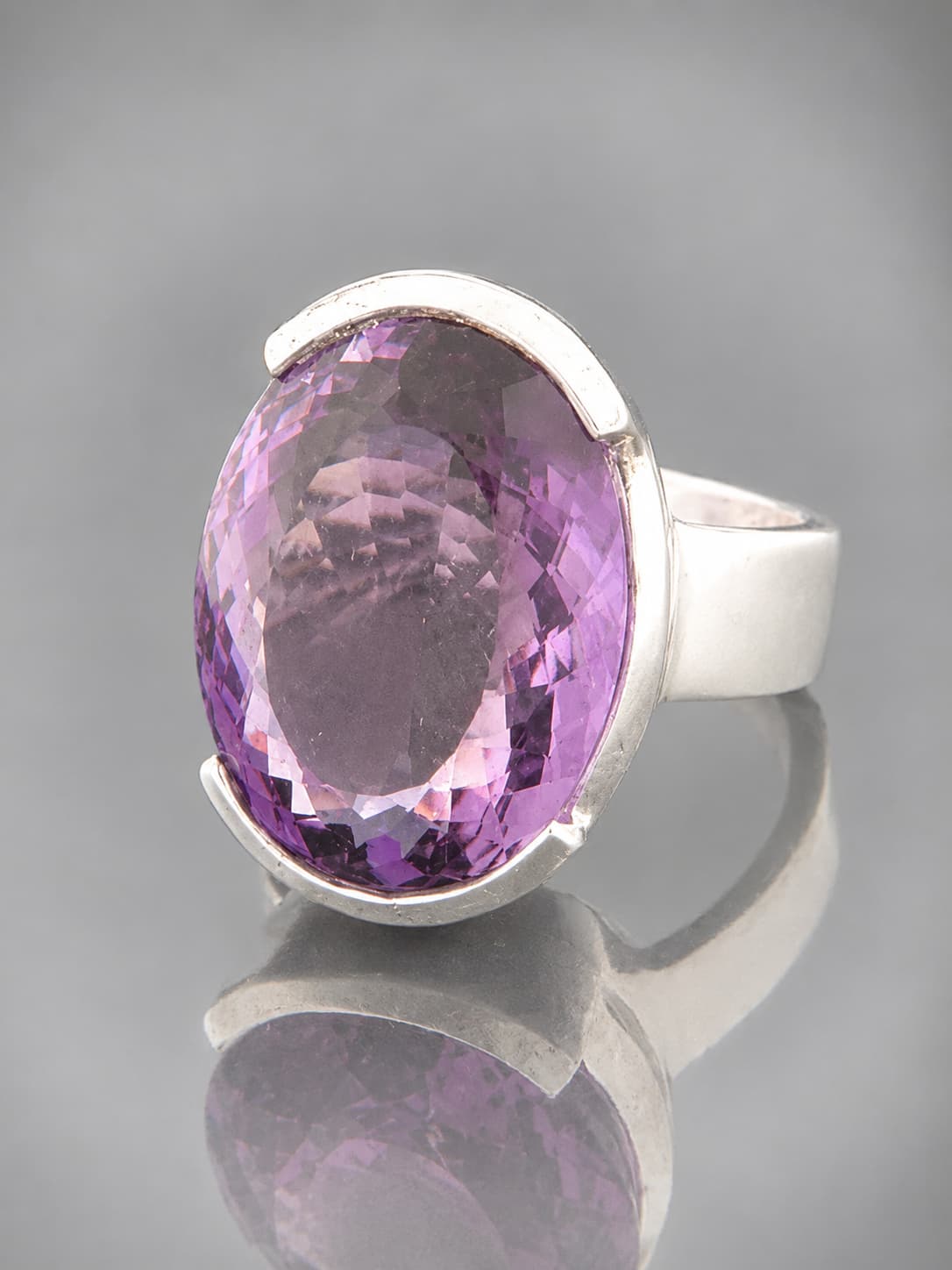 amethyst ring set in sterling silver with a large oval gemstone.